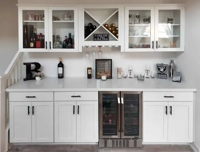 Home bar in Temecula with white Shaker cabinets, X-shaped wine storage, glass uppers and a dual-zone wine fridge