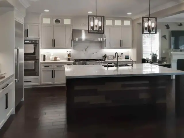 Crowne Hill Estates kitchen in Temecula with white Shaker cabinets, quartzite counters and an oversized island wrapped in reclaimed lumber