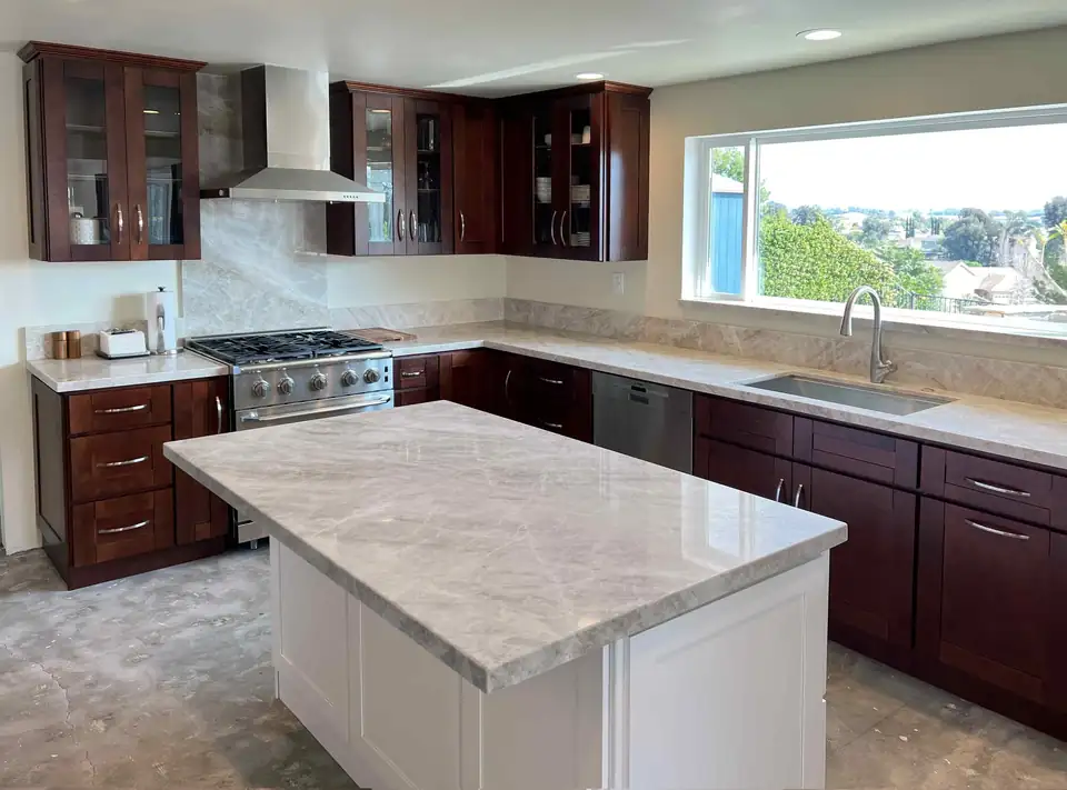 Kitchen remodeling Temecula: Meadowview Estates open-concept kitchen with espresso Shaker cabinets, light quartzite counters, a white island and a wide panoramic window